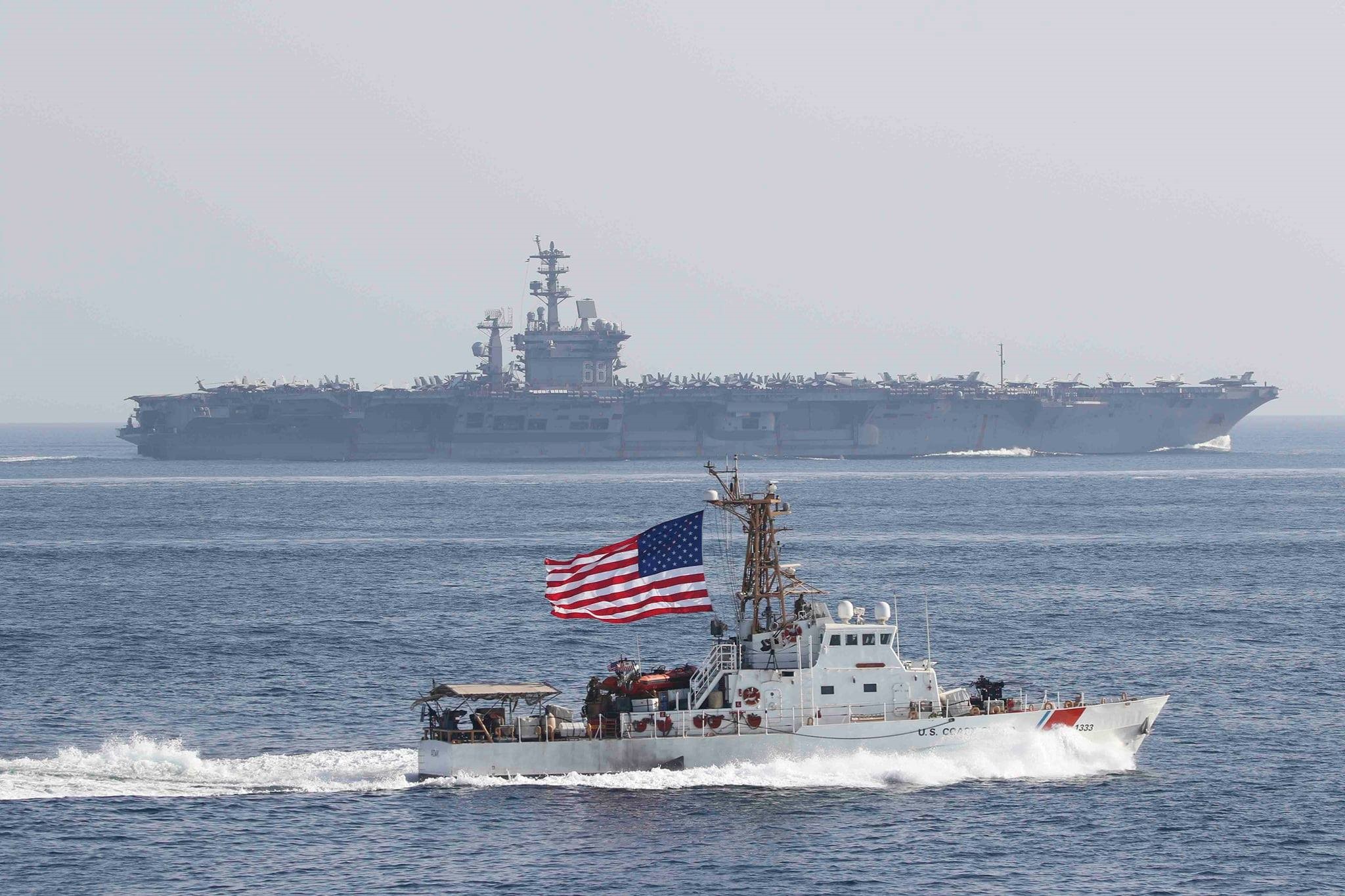 1.	Coast Guard Cutter Adak of PATFORSWA provides escort for aircraft carrier USS Nimitz through the Strait of Hormuz. (U.S. Coast Guard)