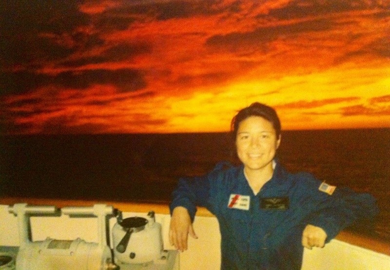 Huling stands on the bridge with of the USCGC JARVIS, on patrol in the Pacific.  She was the Aircraft Commander of the aviation detachment (AVDET) on that patrol.