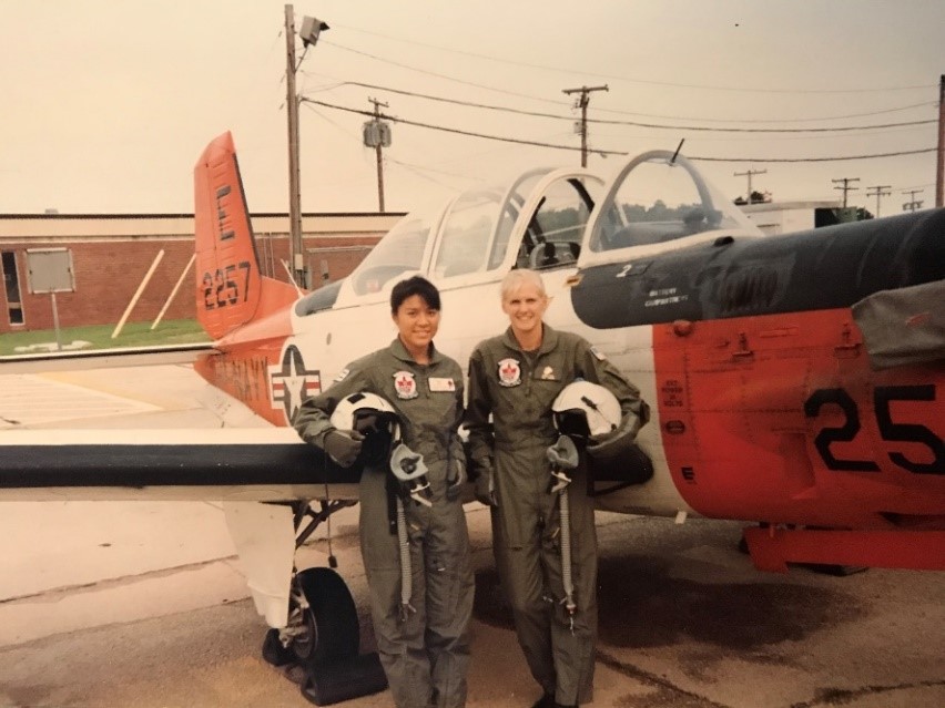 Mara Huling and Sarah Deal stand next to the T-34 Mentor after finishing a cross country flight to Chicago, Illinois.  They were squadron mates in VT-3 "Red Knights."