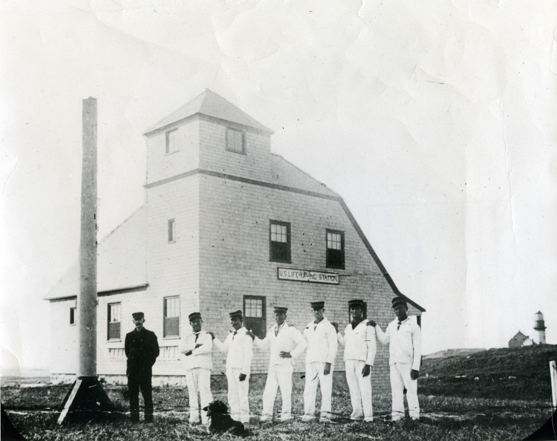 Gay Head Lifesaving Station’s crewmembers stand in dress whites in front of the brand-new station building, including an attached watchtower (Courtesy of the Martha’s Vineyard Museum)